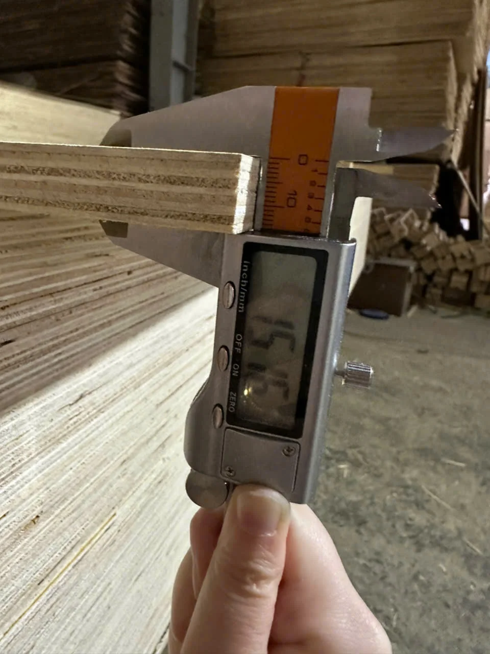 Quality inspection of 11mm plywood thickness at HCPLY Vietnam factory demonstrating measurement accuracy